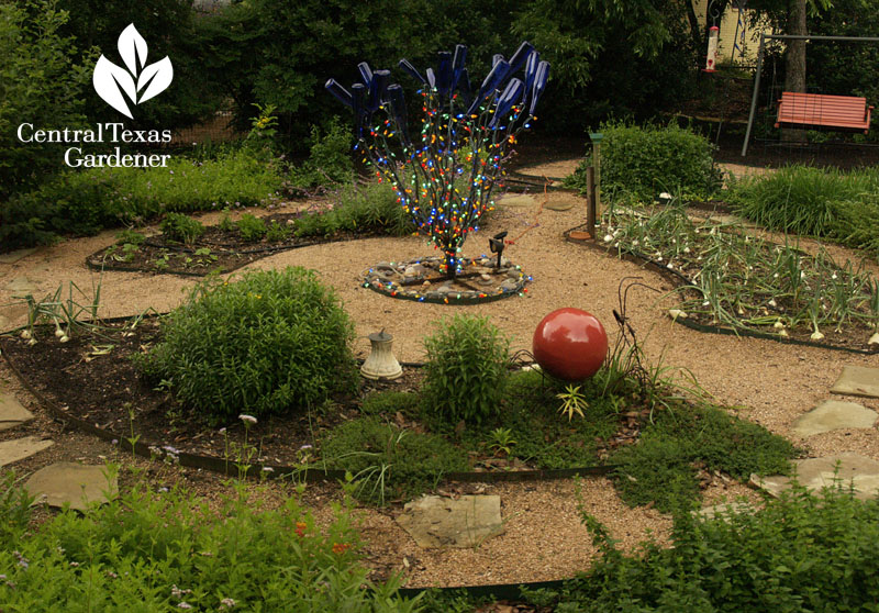 Circle vegetable bed with art sculpture 