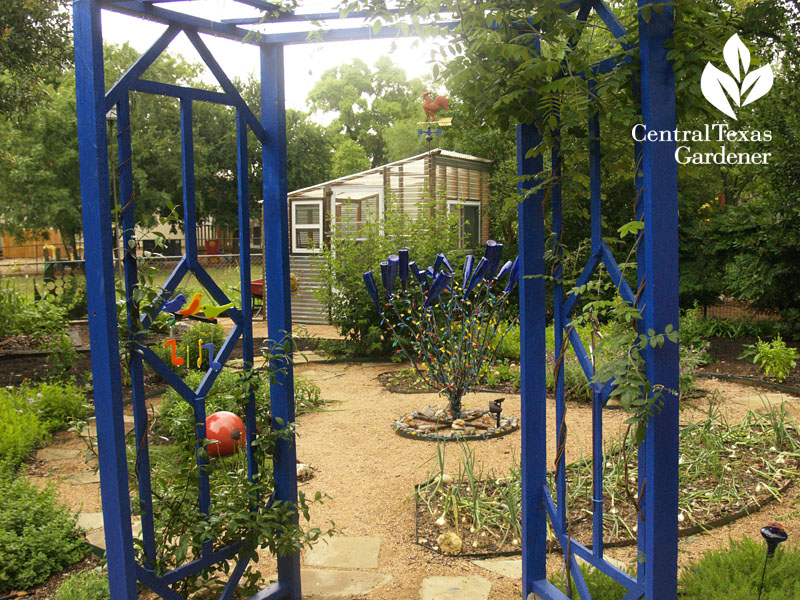 Blue arbor entrance to vegetable garden central texas gardener