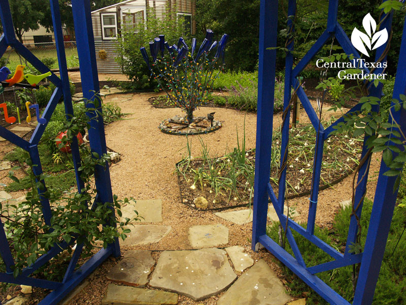 Blue gates entrance to vegetable garden 