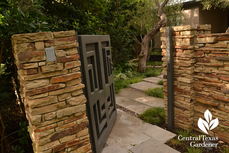 stone walls steel entrance gate courtyard Central Texas Gardener
