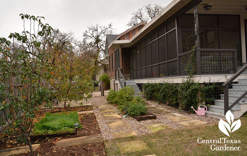 screened in porch view to vegetable beds and fruit trees Central Texas Gardener