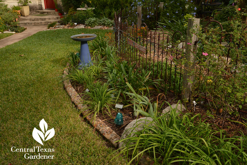 cute garden edgers against curving fence garden room Central Texas Gardener