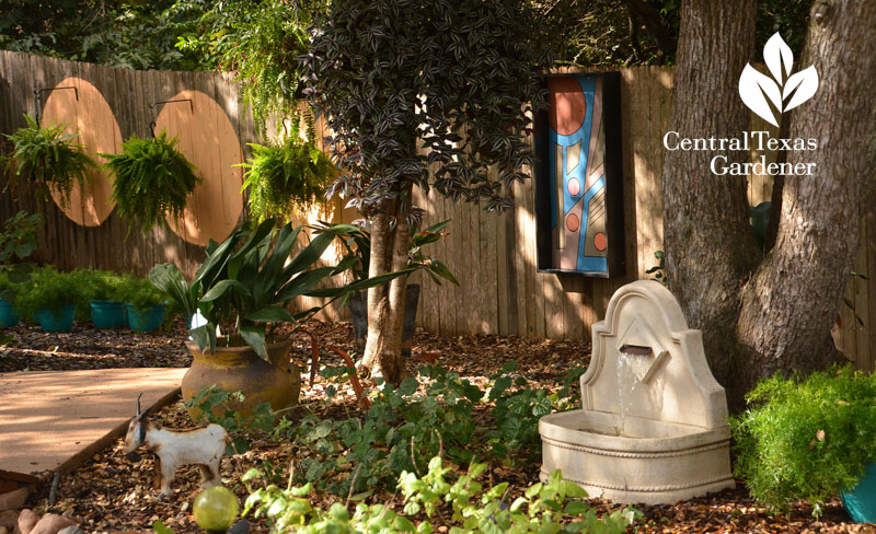 garden fountain garden art on fence shade garden Central Texas Gardener