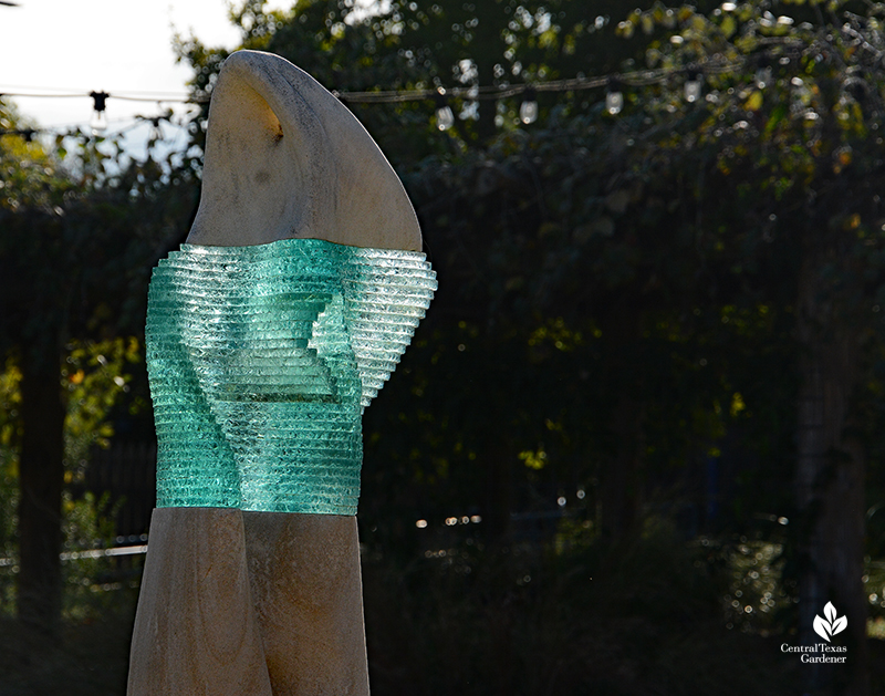 J.J. Priour turquoise glass and limestone sculpture catches light Wildflower Center