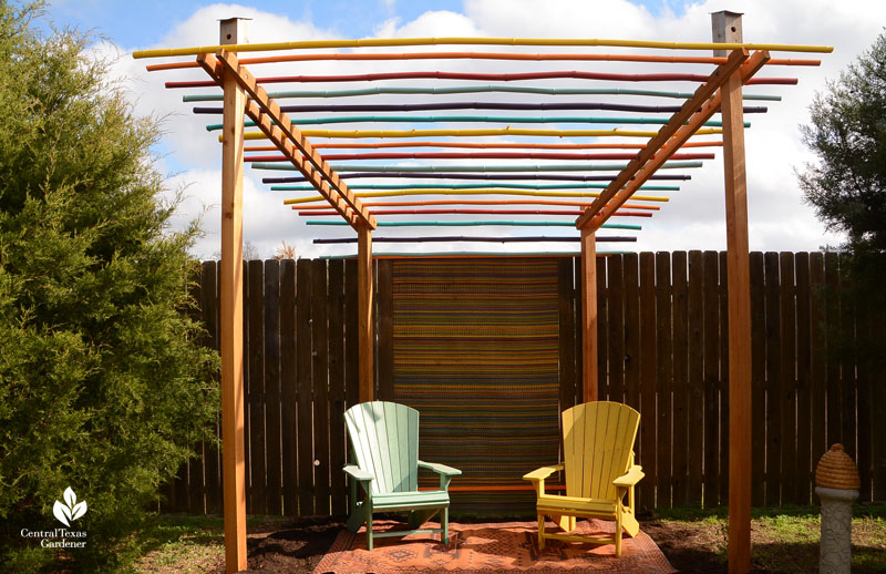 cozy cabana bamboo pergola with colorful metal garden chairs underneath