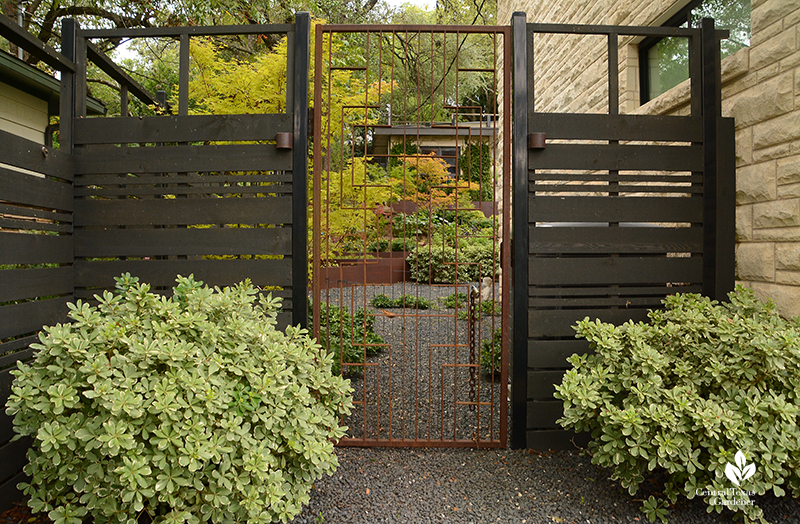 Open weave privacy fence with patterned steel gate Harper Dujon Central Texas Gardener