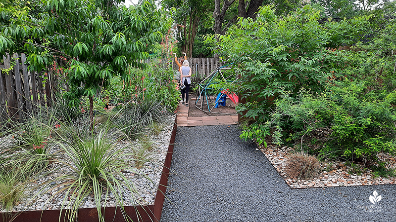 Texas basalt path raised steel bed red yucca plants Red Baron peach tree native Mexican buckeye Open Envelope Studio design