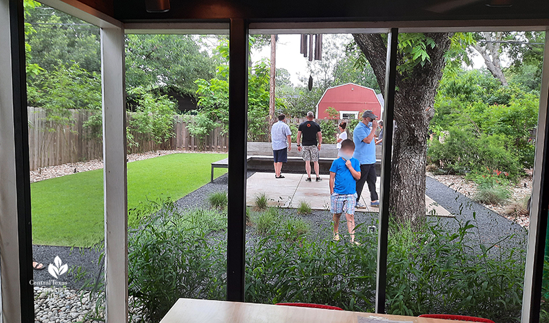 screened in porch to backyard pecan tree Texas basalt path concrete path and wide bench and wall native plants Open Envelope Studio