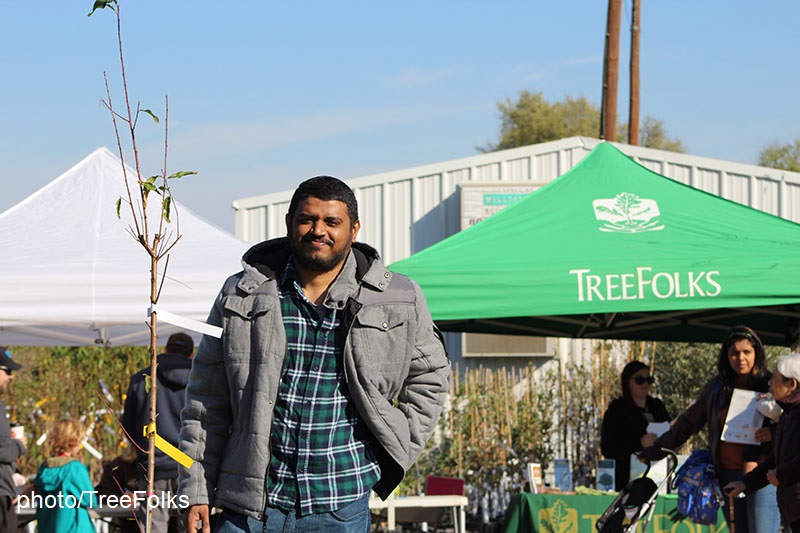 man with TreeFolks tree sapling