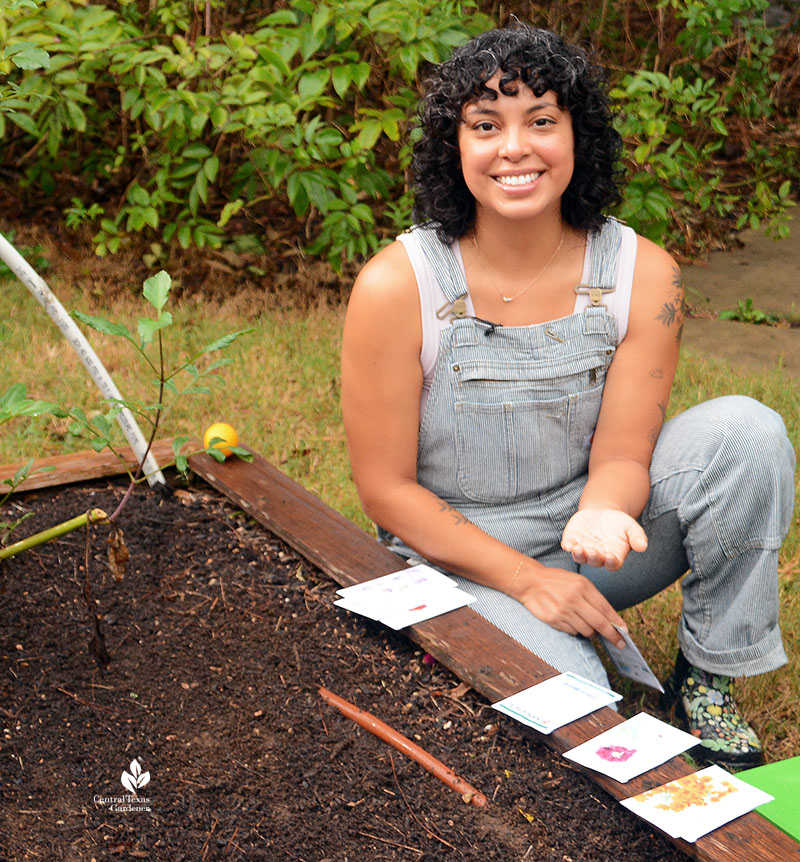 woman in garden showing seeds in her hand