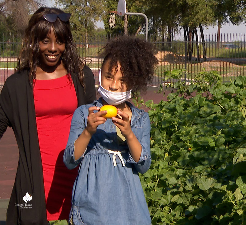 woman and daughter with fresh picked lemon cucumber