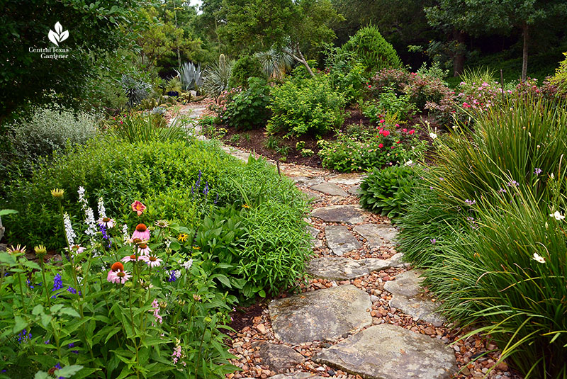 flagstone path through flowers and shrubs 