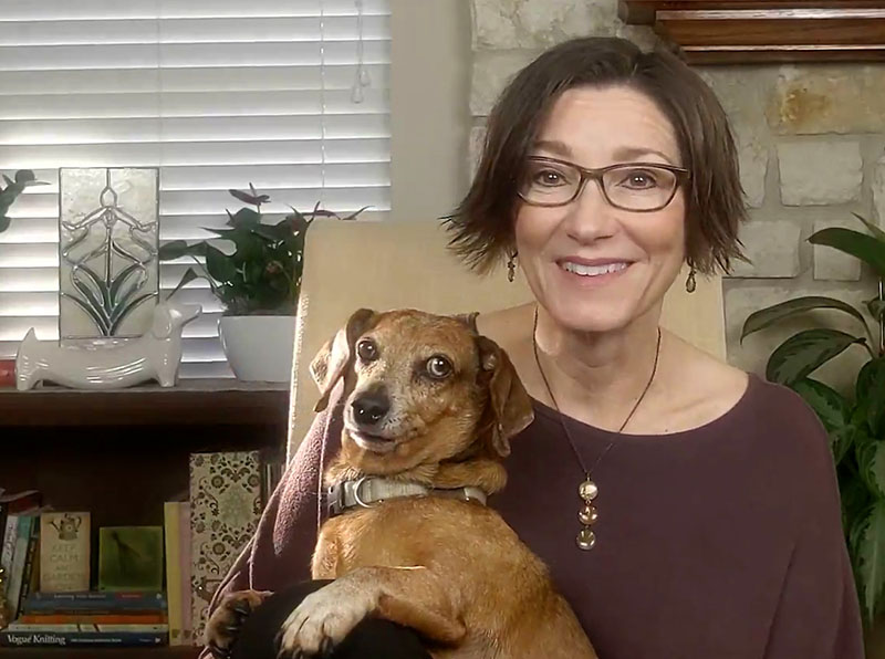 woman and dachshund in living room  