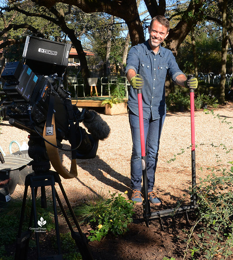 man with broadfork to loosen soil