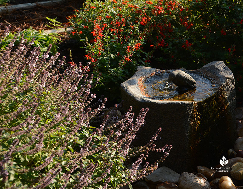 small stone fountain with plants