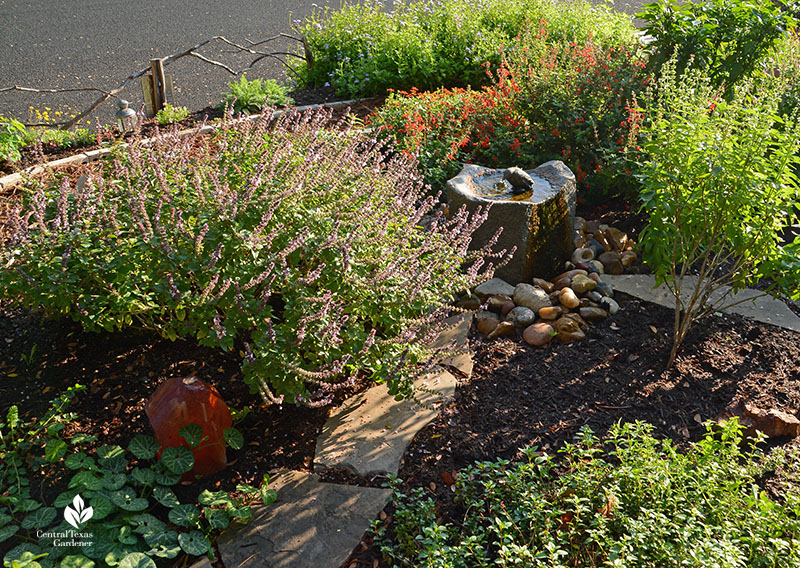 small stone fountain flowering plants