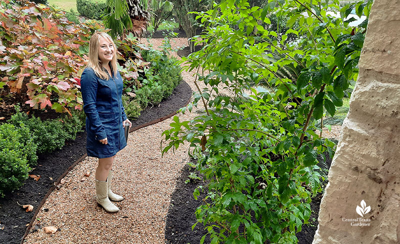 woman on path bordered by plants