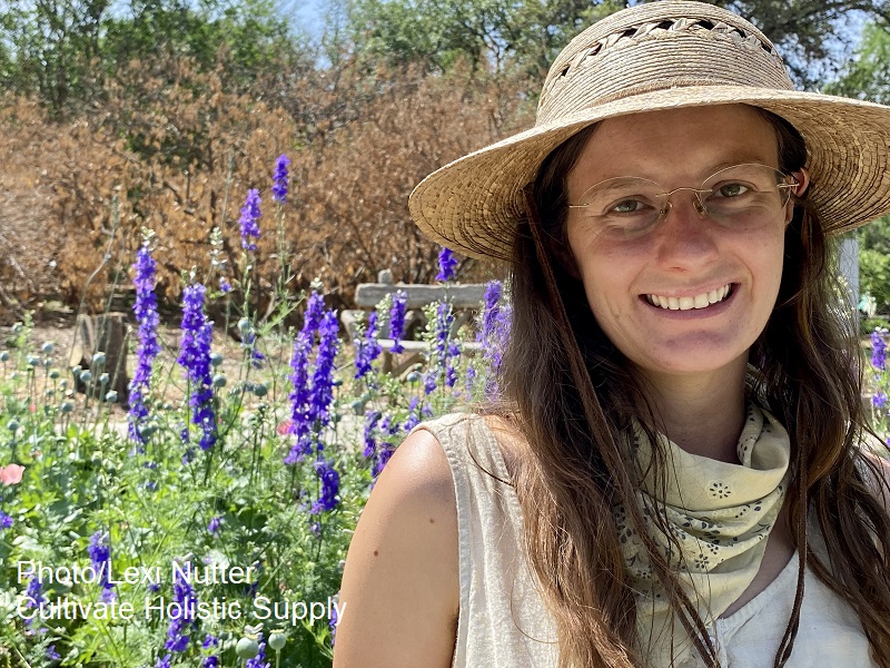 woman in front of blue flowers