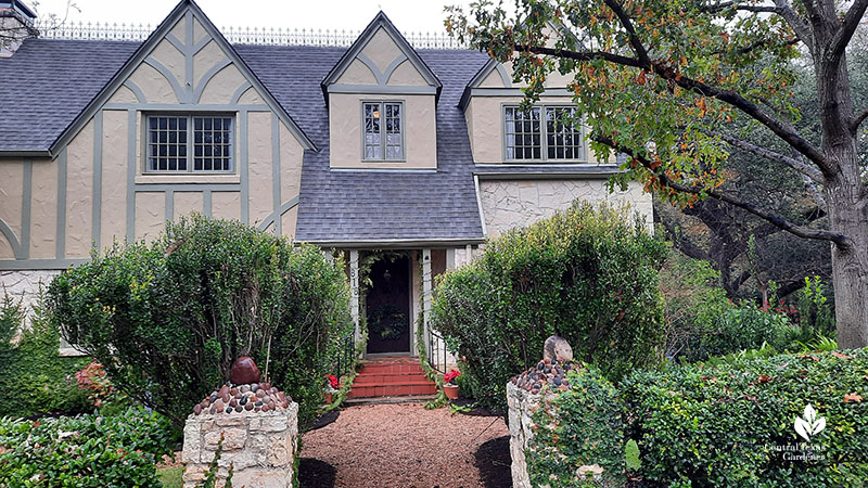 house with entrance pillars and shrubs