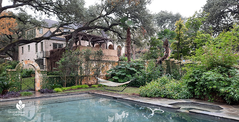 stone wall around pool to house above