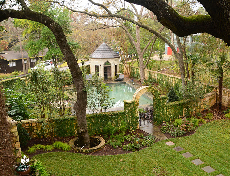 stone wall around pool and small gazebo