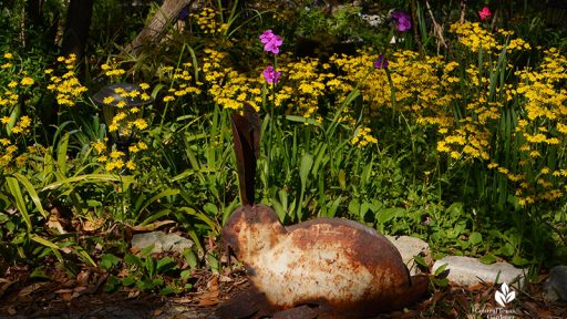 bunny garden sculpture with yellow flowers