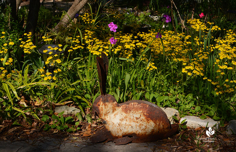 bunny garden sculpture with yellow flowers