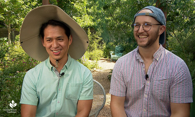 two men wearing hats in garden