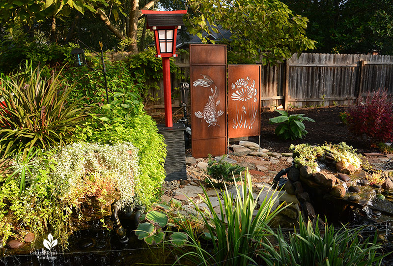 red Japanese lantern and decorative cutout panels with fish and plant cutouts