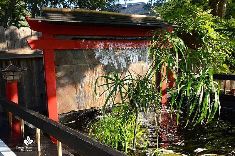 waterfall on clear wall in pond