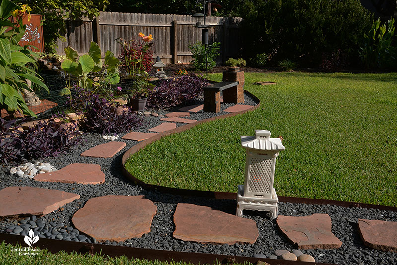 stone and gravel path against lawn Japanese lantern 