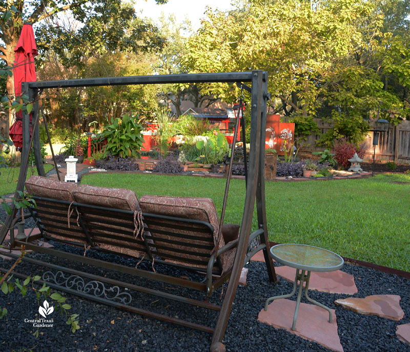 swinging bench overlooking lawn and island garden