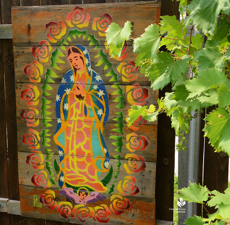 grapes against colorful Our Lady of Guadalupe wooden panel