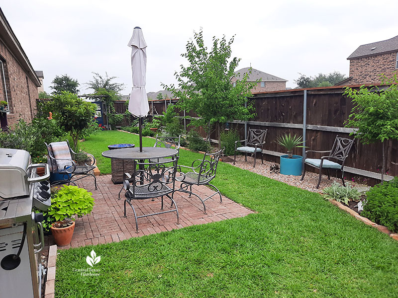 brick patio lawn garden beds along house and fence in narrow side yard