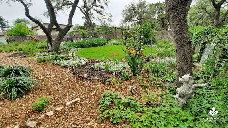 river rock path against border of flowers going uphill to sunny areas