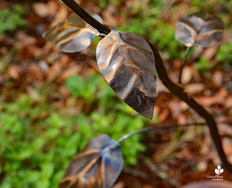 coppery metal leaf on garden sculpture