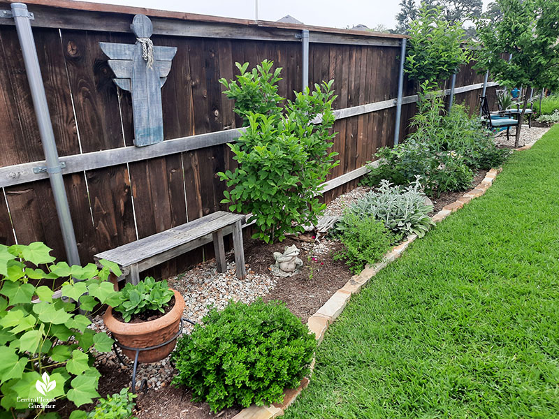 handmade wooden bench in fence garden border 