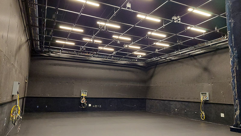 empty studio with work lights on ceiling grids