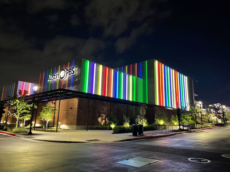 colorful lighted panels on side of building with Austin PBS sign and logo