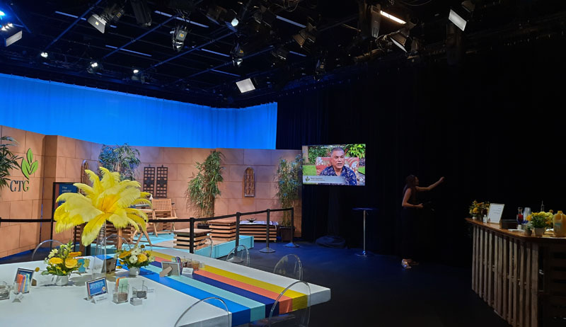 colorful table in studio with CTG set and TV screen on wall