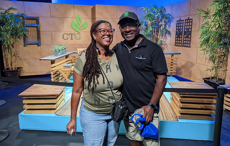 smiling woman and man in front of CTG studio set