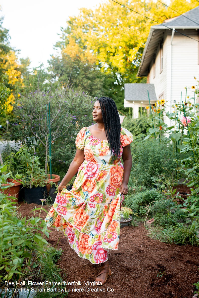 woman in floral dress walking through garden