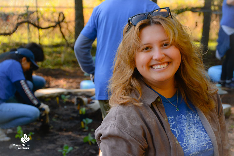 young woman smiling in a garden