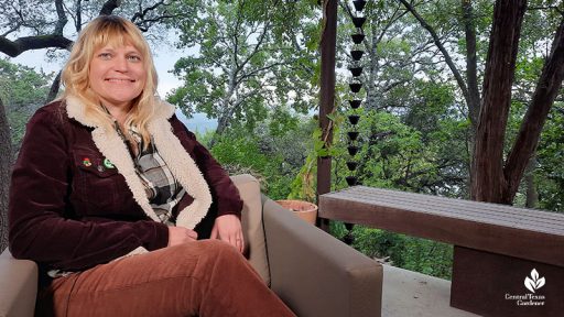 smiling woman with garden behind