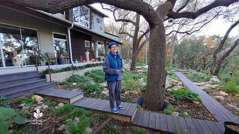 woman on backyard boardwalk; house in background