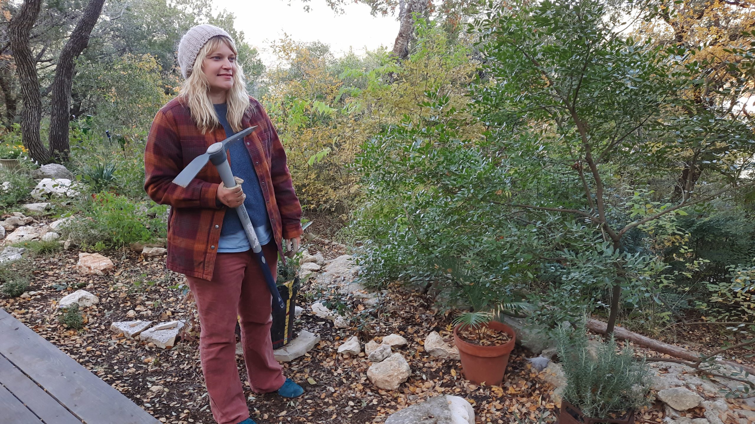 woman holding garden tool in garden 