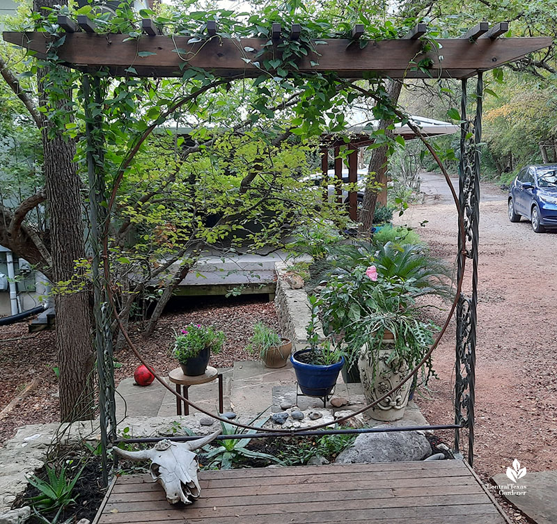 moon gate supported by vintage wrought iron porch posts