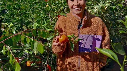 woman holding tangerine