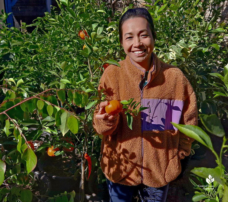 woman holding tangerine