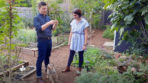 man and woman in garden with their dog